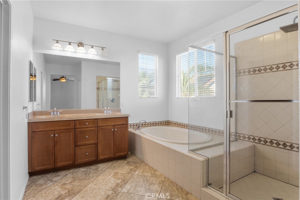 30272 Tattersail Way Menifee, CA 92584 - Photo 21 of 44 a spacious bathroom with a tub sink shower and mirror