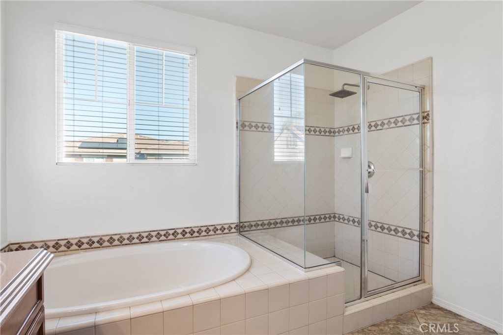 30272 Tattersail Way Menifee, CA 92584 - Photo 22 of 44 a bathroom with a tub and a shower