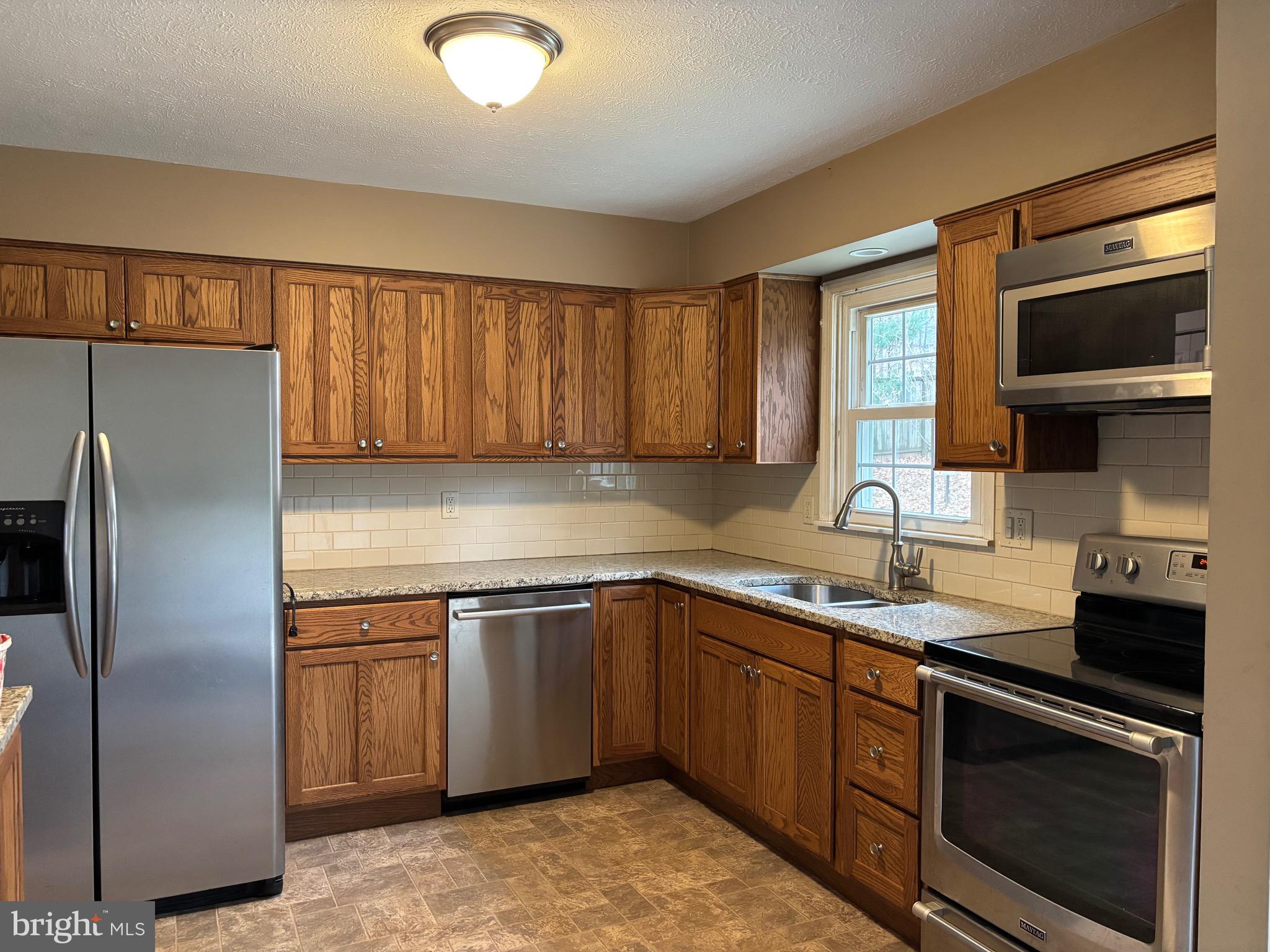 2213 Green Haven Way Hampstead, MD 21074 - Photo 7 of 15 a kitchen with a sink appliances and cabinets