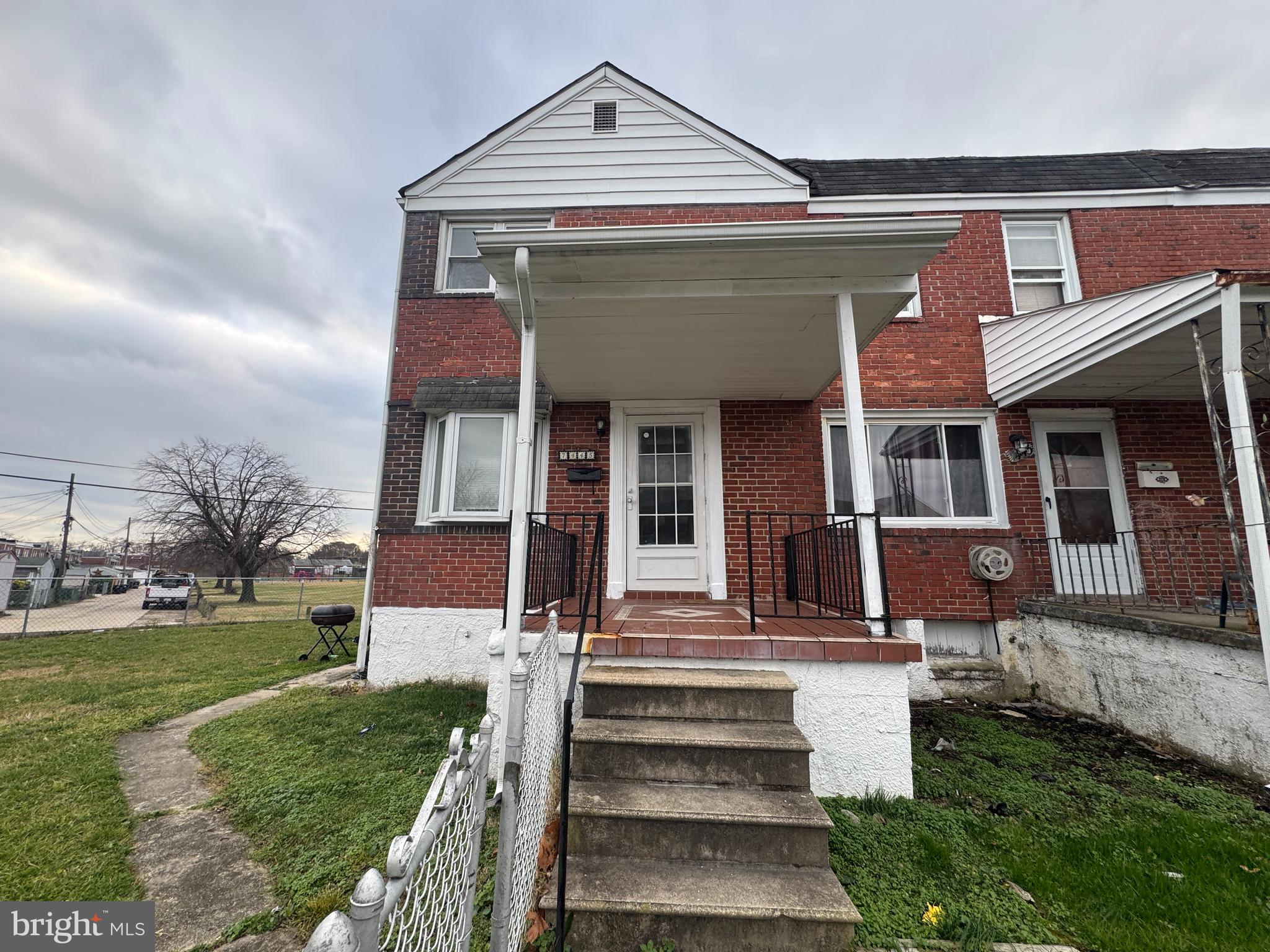 7445 Edsworth Road Baltimore, MD 21222 - Photo 1 of 37 a front view of a house with a yard
