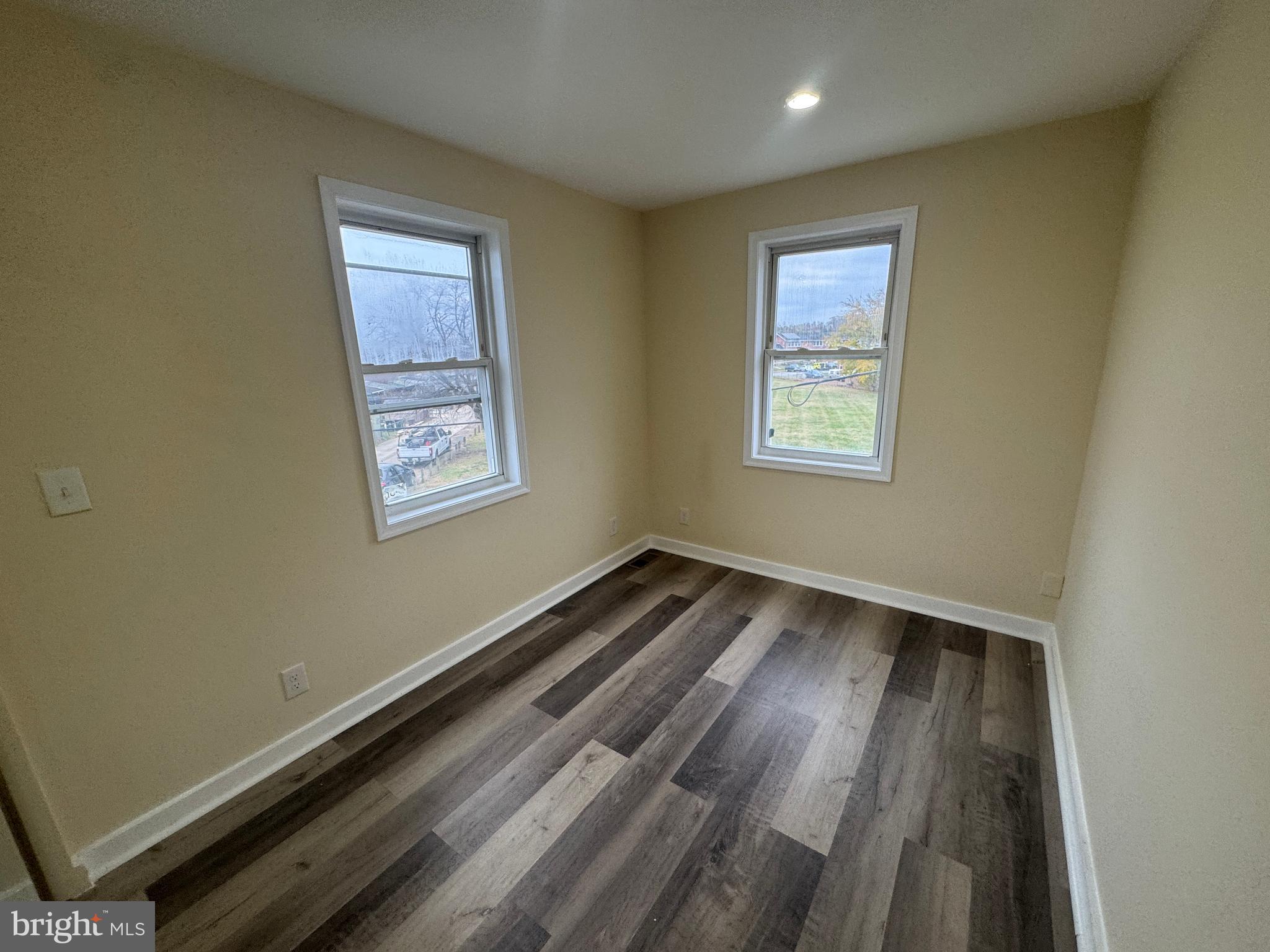 7445 Edsworth Road Baltimore, MD 21222 - Photo 21 of 37 a view of wooden floor and windows in a room