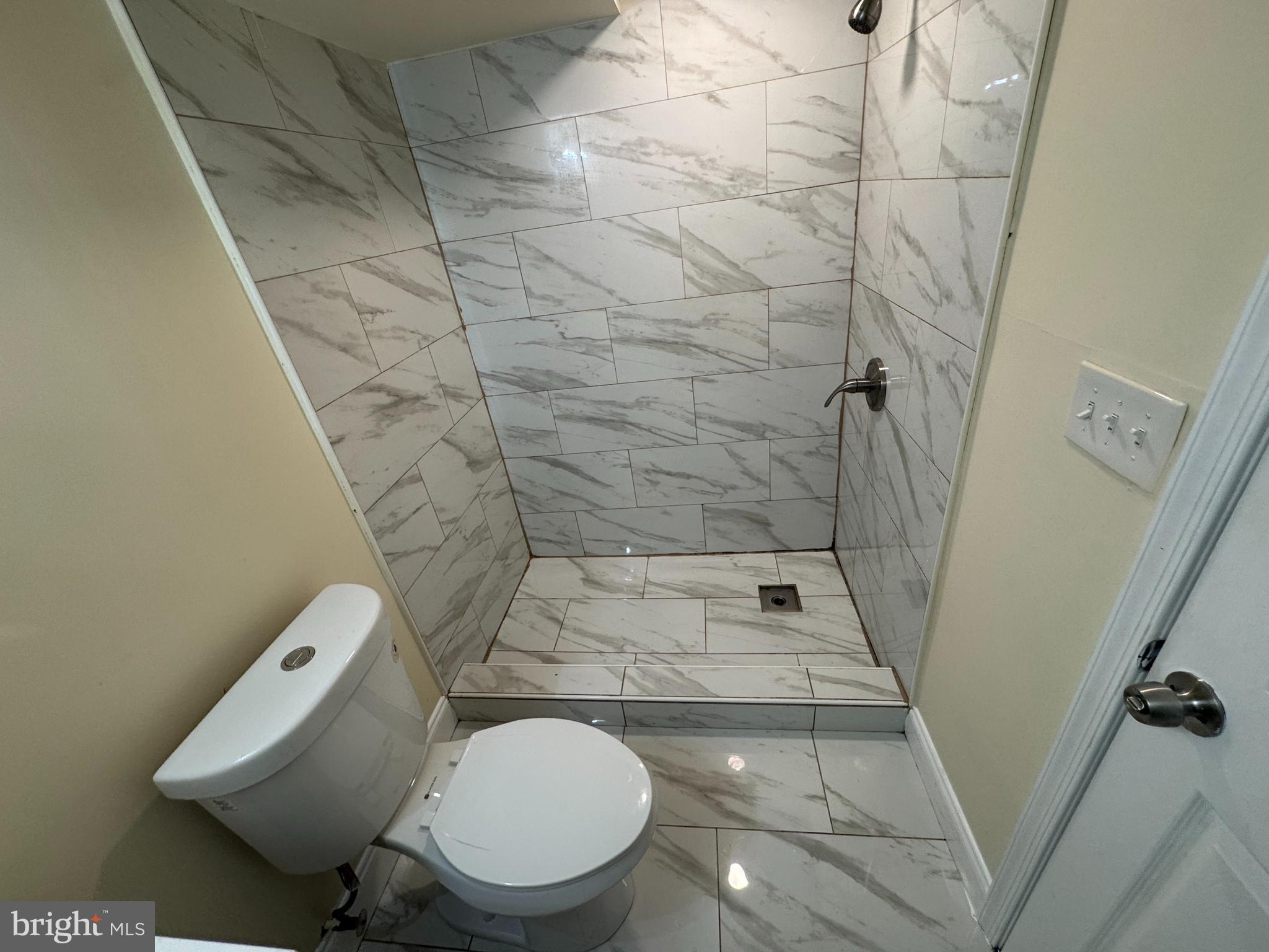 7445 Edsworth Road Baltimore, MD 21222 - Photo 25 of 37 a bathroom with a toilet and a shower