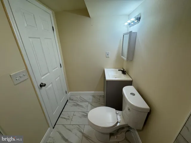 a bathroom with a sink toilet and mirror