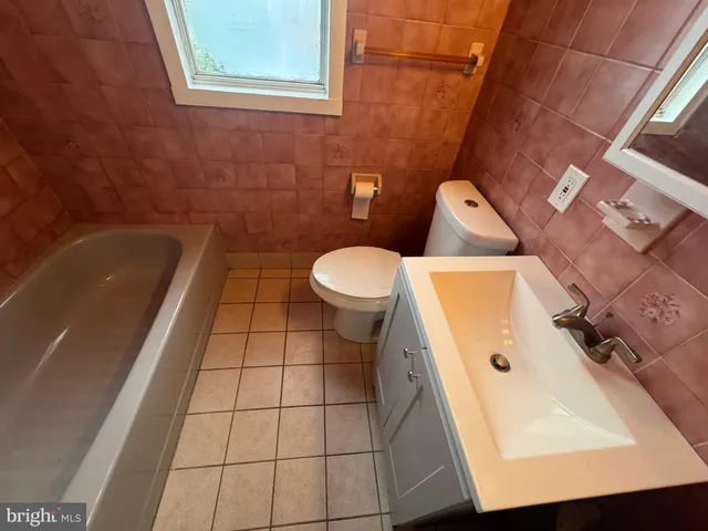 a bathroom with a sink a toilet and bathtub