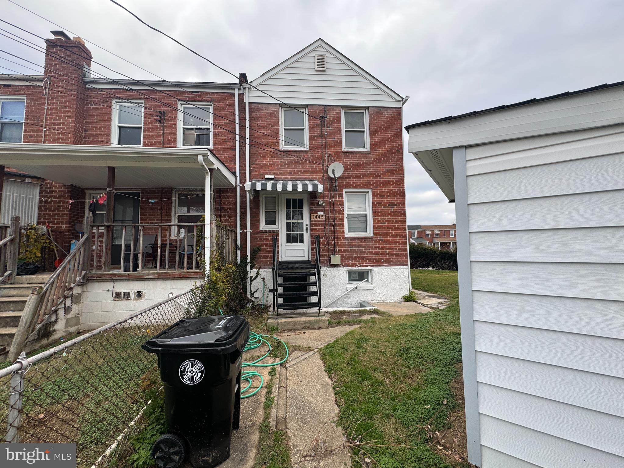 7445 Edsworth Road Baltimore, MD 21222 - Photo 36 of 37 a front view of a house with garden
