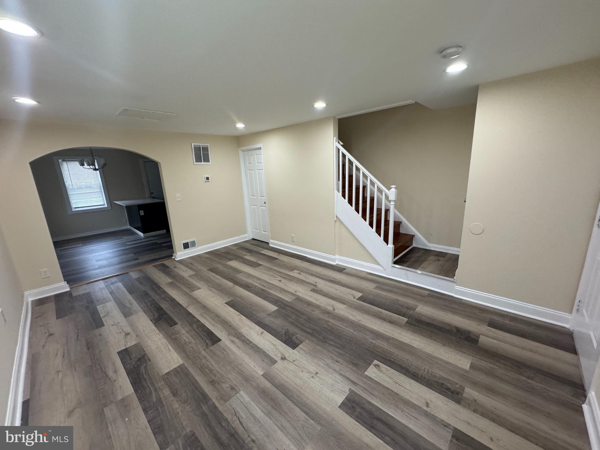 7445 Edsworth Road Baltimore, MD 21222 - Photo 4 of 37 a view of a hallway with wooden floor and staircase