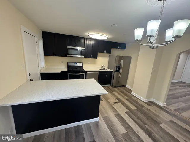 a large kitchen with a table and chairs