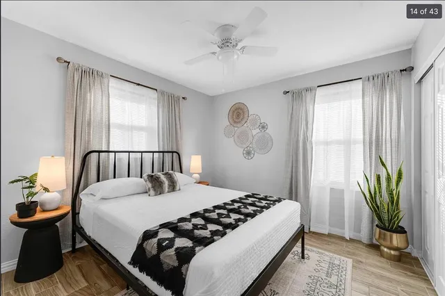 a bedroom with a bed and a chandelier