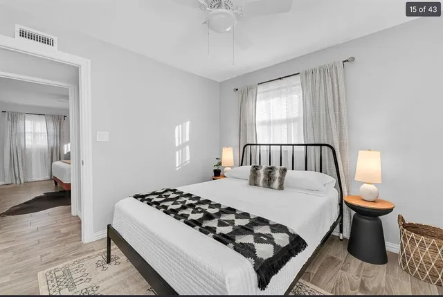 a bedroom with a large bed and a chandelier