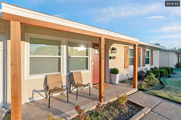 a front view of a house with outdoor seating