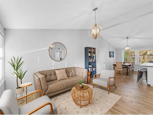 a living room with furniture a rug and a window