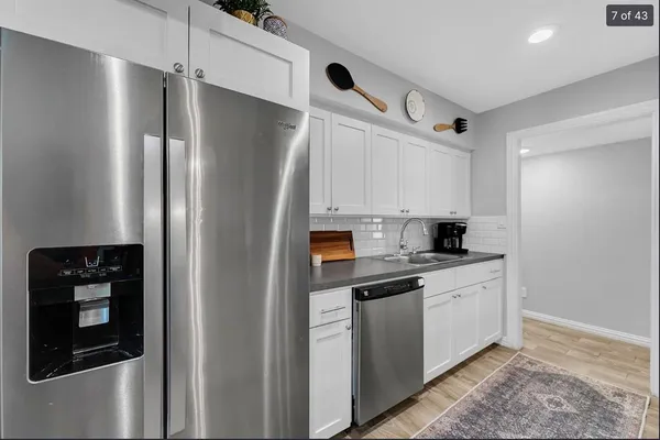 a kitchen with stainless steel appliances a refrigerator sink and cabinets