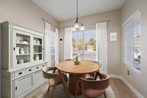 a dining room with furniture a chandelier and window