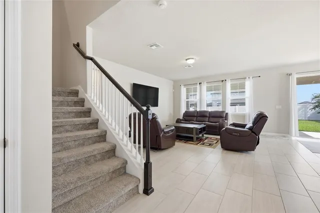 a large kitchen with stainless steel appliances kitchen island granite countertop a counter top space a sink refrigerator and microwave