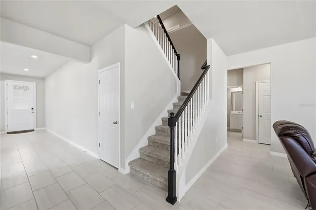 a spacious bathroom with a double vanity sink a mirror and a toilet