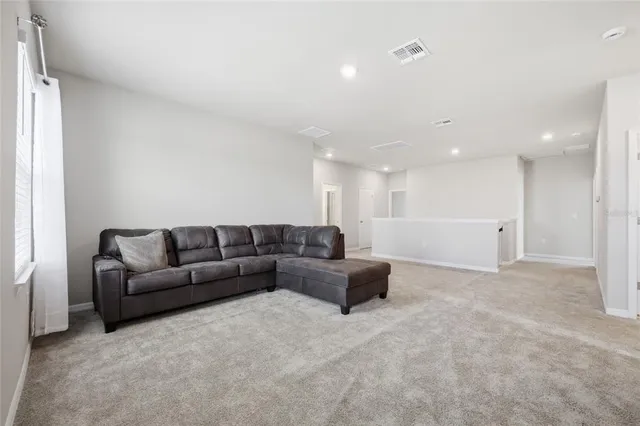 a spacious bedroom with a bed and a window