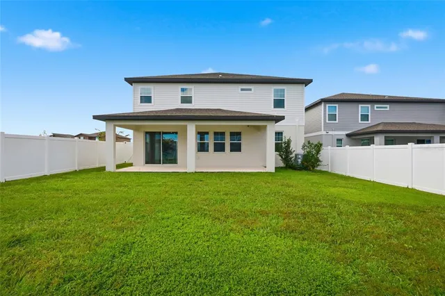 a view of house with yard