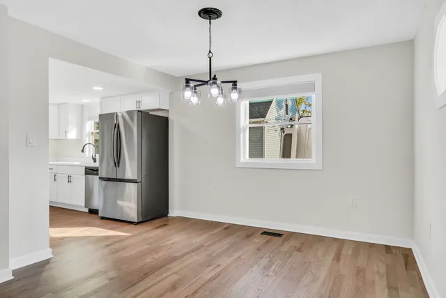 a kitchen with stainless steel appliances a refrigerator and a stove top oven