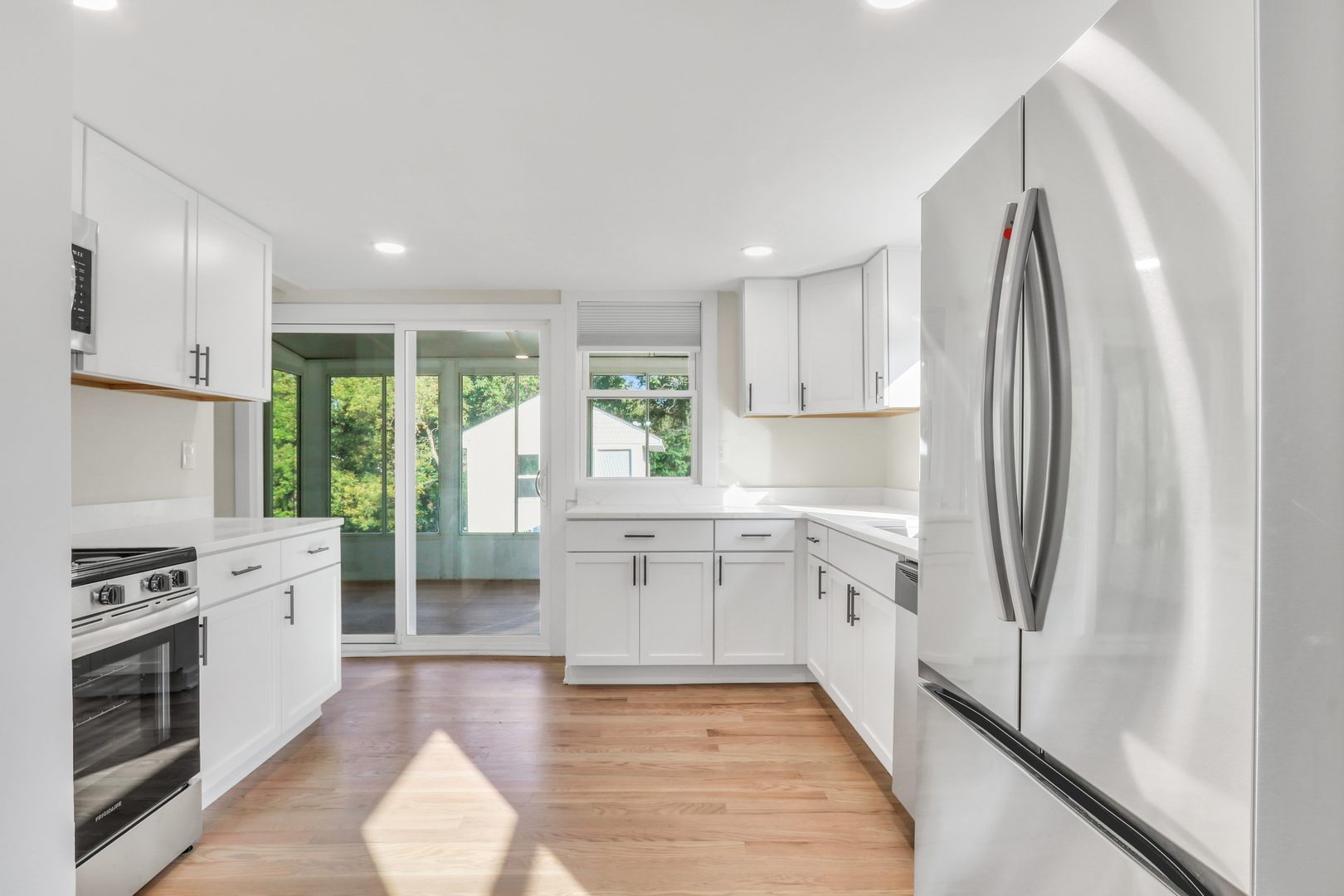 27065 North Ridge Street Wauconda, IL 60084 - Photo 17 of 33 a kitchen with white cabinets and stainless steel appliances