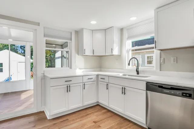 a kitchen with sink cabinets and wooden floor
