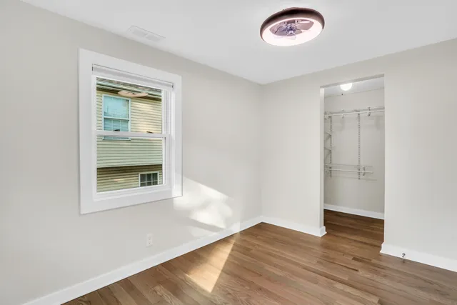 an empty room with a door and wooden floor