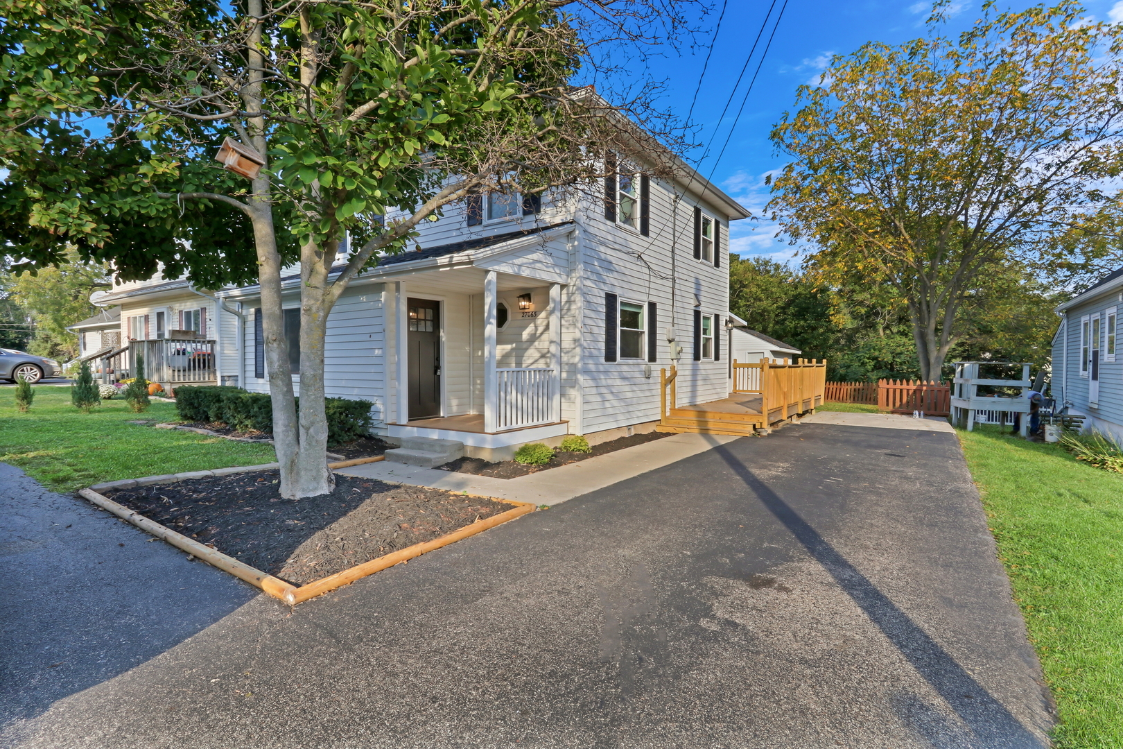 27065 North Ridge Street Wauconda, IL 60084 - Photo 3 of 33 a view of a white house with a yard and large tree
