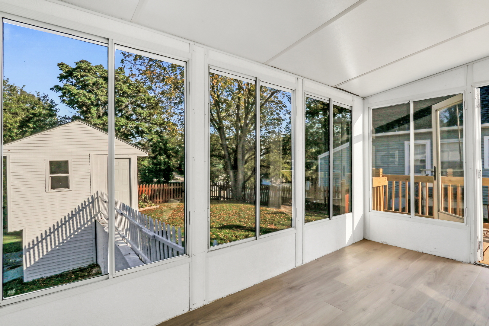 27065 North Ridge Street Wauconda, IL 60084 - Photo 32 of 33 a view of a porch with a floor to ceiling window and wooden floor