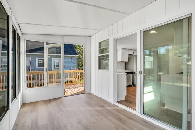 a view of an entryway with wooden floor