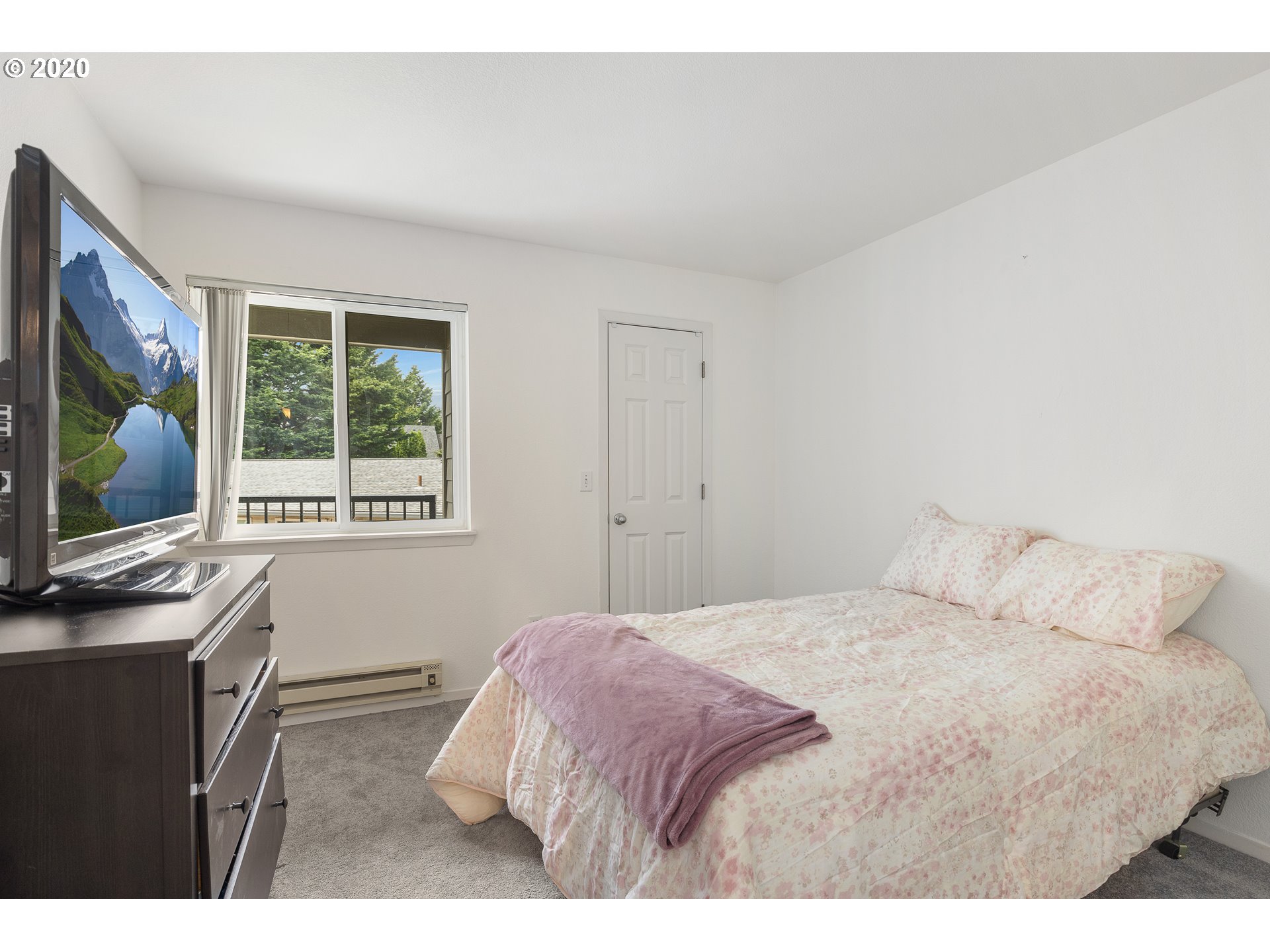 5225 Jean Road, Unit 304 Lake Oswego, OR 97035 - Photo 16 of 23 a bedroom with a bed window and a flat screen tv