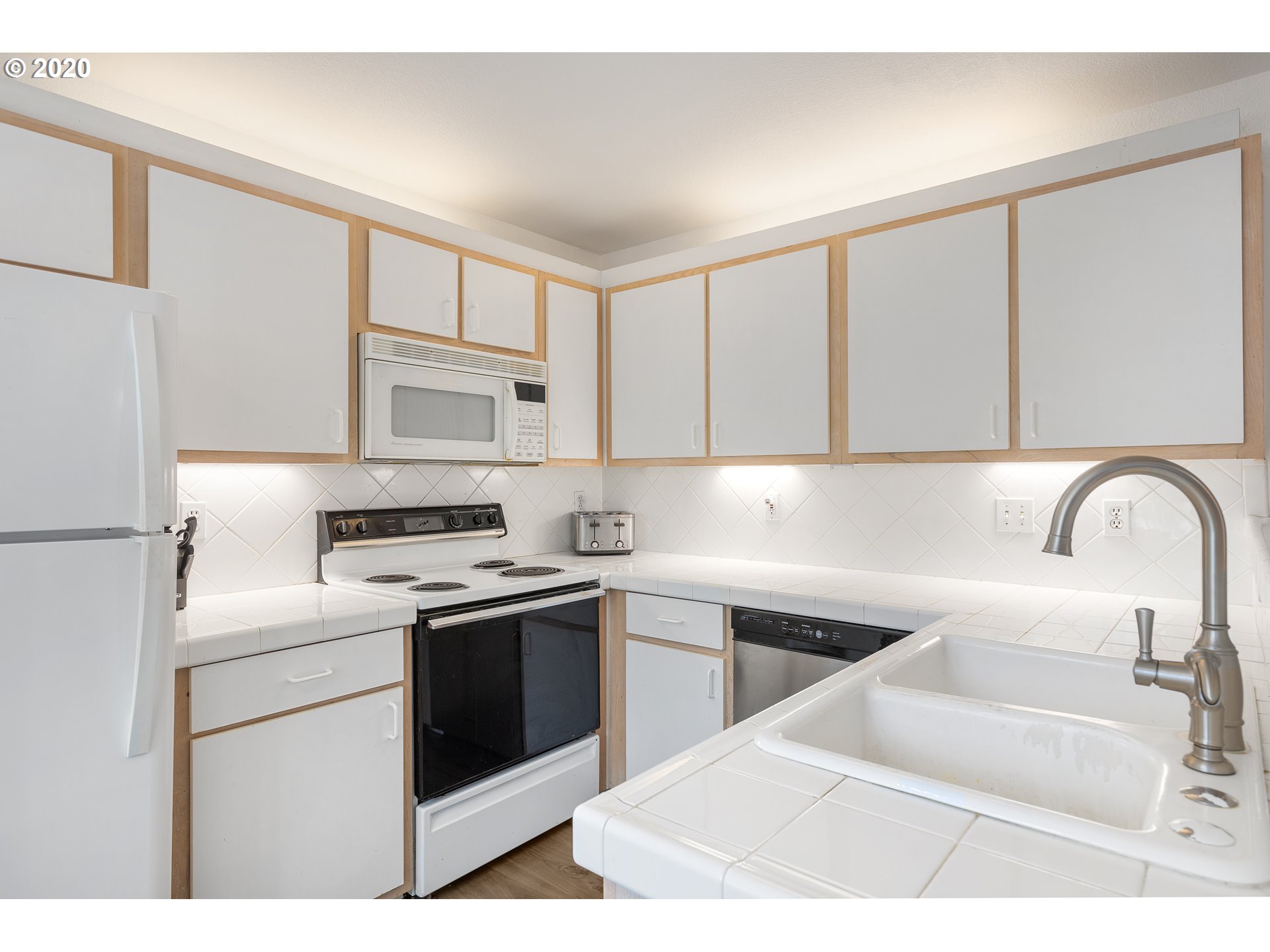 5225 Jean Road, Unit 304 Lake Oswego, OR 97035 - Photo 8 of 23 a kitchen with a sink white cabinets and appliances