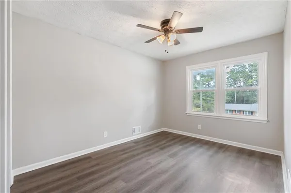 a view of room with window and ceiling fan