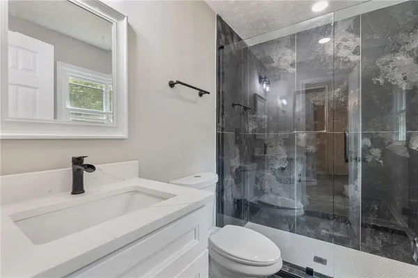 a bathroom with a shower a toilet and a shower