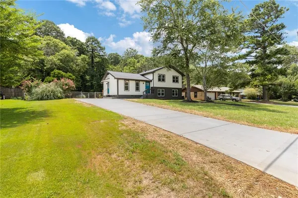 a view of a house with swimming pool and porch
