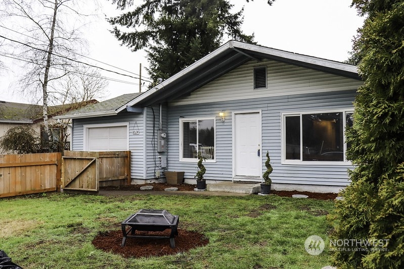 18124 Corvallis Street Southwest Rochester, WA 98579 - Photo 1 of 21 a front view of a house with a garden