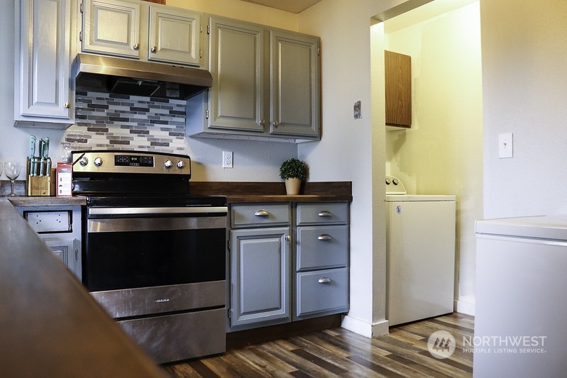 18124 Corvallis Street Southwest Rochester, WA 98579 - Photo 4 of 21 a kitchen with stainless steel appliances granite countertop a stove and a refrigerator with cabinets