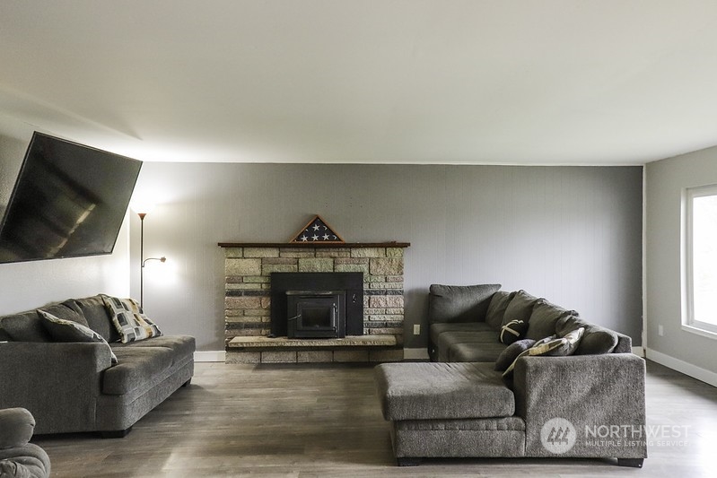 18124 Corvallis Street Southwest Rochester, WA 98579 - Photo 6 of 21 a living room with furniture and a fireplace