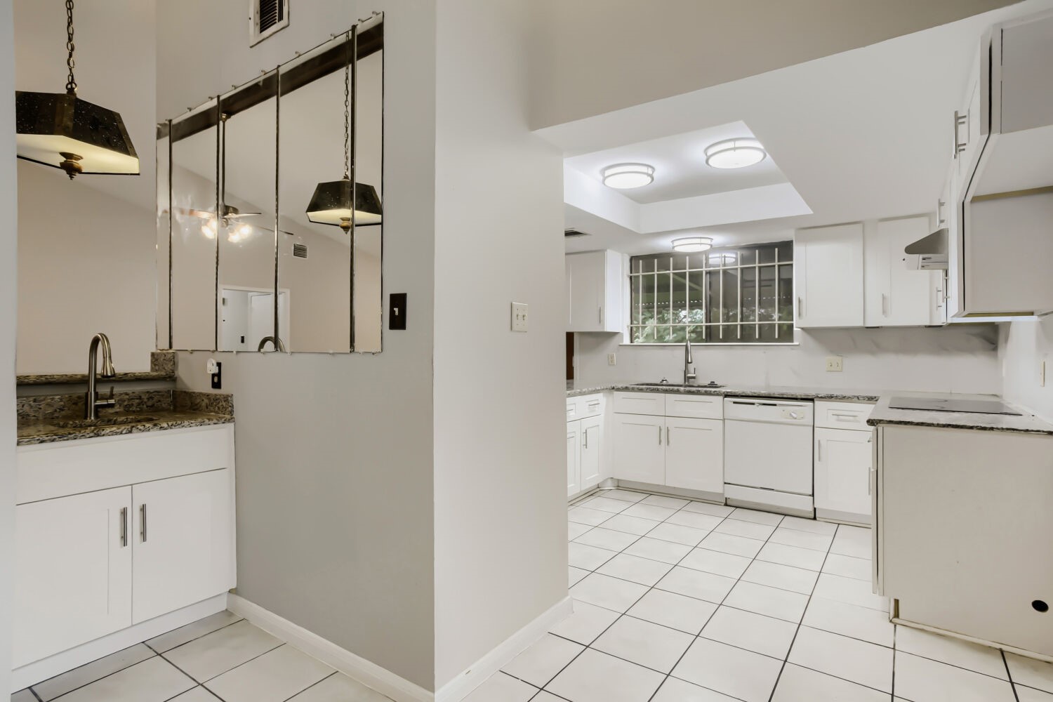 10103 Inwood Shadows Street Houston, TX 77088 - Photo 10 of 32 a kitchen with white cabinets and appliances