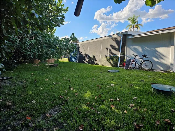 a kitchen with granite countertop a sink a stove a refrigerator and cabinets