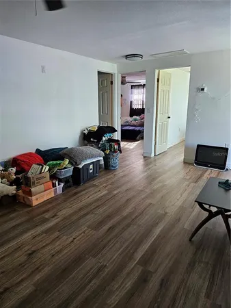 a bedroom with a bed next to a window and a chandelier