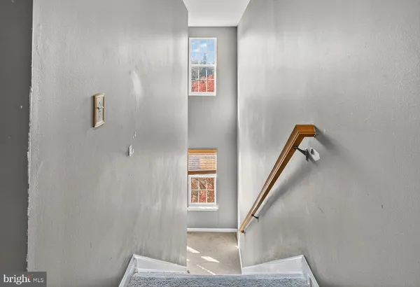 a view of staircase with white walls