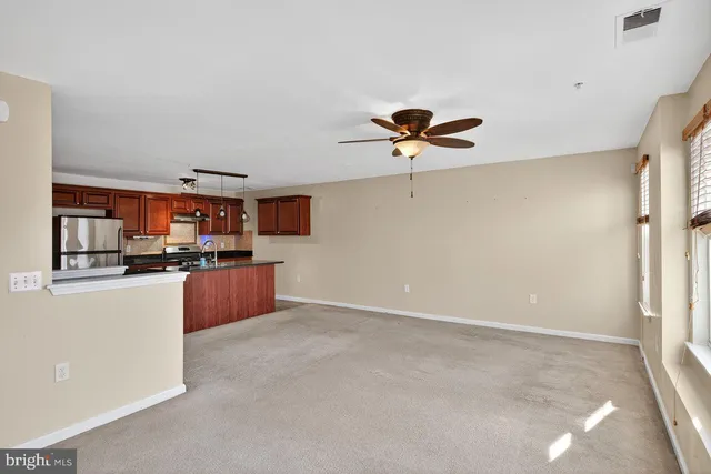 a view of kitchen with stainless steel appliances kitchen island a refrigerator sink and cabinets
