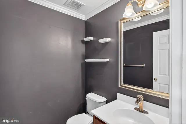 a bathroom with a sink mirror and toilet
