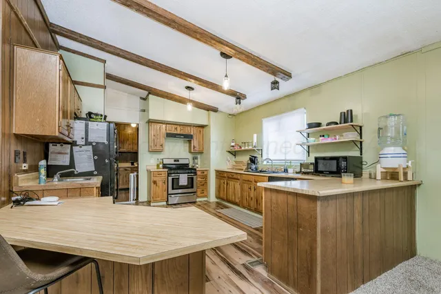 a kitchen with stainless steel appliances granite countertop a stove sink and cabinets