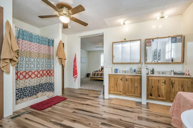 a bedroom with bed and a chandelier