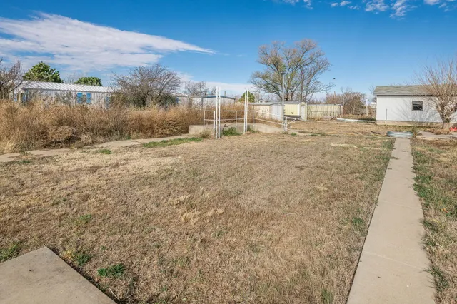 a living room with furniture a fireplace and a ceiling fan