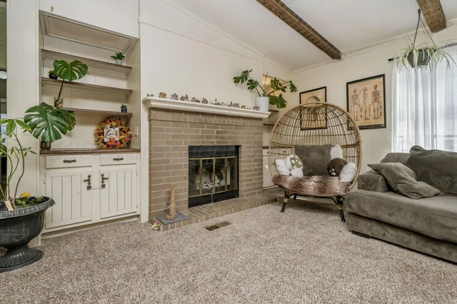 a living room with furniture and kitchen view