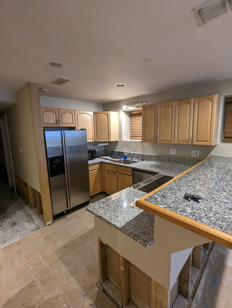 1407 North Mohawk Street, Unit G Chicago, IL 60610 - Photo 2 of 11 a kitchen with stainless steel appliances granite countertop a sink stove and refrigerator