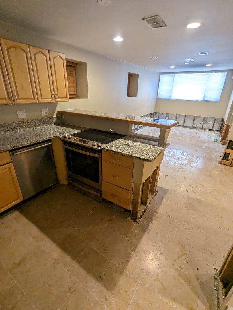 1407 North Mohawk Street, Unit G Chicago, IL 60610 - Photo 3 of 11 a kitchen with stainless steel appliances granite countertop a stove and a sink