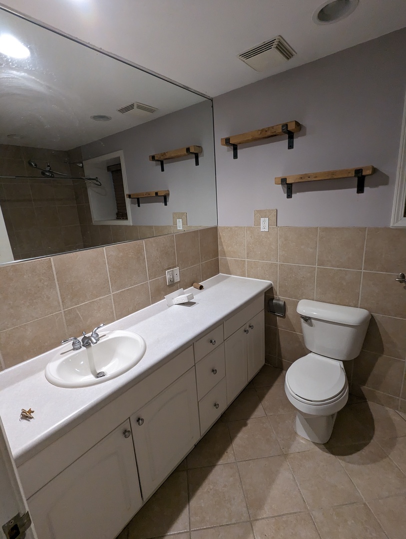 1407 North Mohawk Street, Unit G Chicago, IL 60610 - Photo 8 of 11 a bathroom with a toilet sink and mirror
