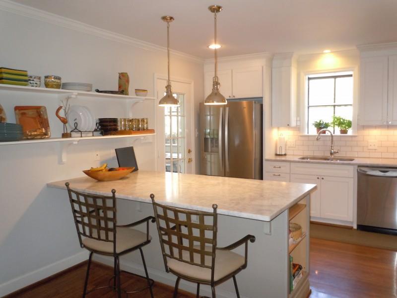 149 Alton Road Nashville, TN 37205 - Photo 8 of 19 a kitchen with kitchen island a refrigerator a stove a sink and chairs